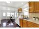 Traditional kitchen with wood cabinets and adjacent dining area with large windows at 1028 Albany St, Indianapolis, IN 46203