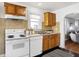 Traditional-style kitchen features wooden cabinets, tile backsplash, and white appliances at 1028 Albany St, Indianapolis, IN 46203