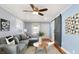 Comfortable living room featuring modern ceiling fan and trendy sliding barn door at 1028 Albany St, Indianapolis, IN 46203