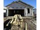Exterior home construction with lumber in the foreground and visible framing at 1089 Tomahawk Pl, Martinsville, IN 46151