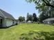 Expansive backyard featuring a neatly kept lawn and mature trees, offering ample space and privacy at 1175 Central Ave, Noblesville, IN 46060