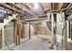 Unfinished basement with concrete floor and water heater at 1175 Central Ave, Noblesville, IN 46060