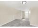 Spacious attic bedroom with gray carpet and hallway access at 1175 Central Ave, Noblesville, IN 46060