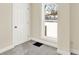 Bedroom with grey carpet, window, and white door at 1175 Central Ave, Noblesville, IN 46060