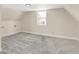 Bright attic bedroom with gray carpet and window at 1175 Central Ave, Noblesville, IN 46060
