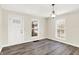 Bright dining room with hardwood floors and new light fixture at 1175 Central Ave, Noblesville, IN 46060