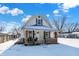 Charming house exterior with brick details and a snow covered yard at 1175 Central Ave, Noblesville, IN 46060
