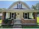 Inviting home with a charming front porch, brick accents, and a neatly landscaped front yard at 1175 Central Ave, Noblesville, IN 46060