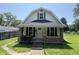 Charming home featuring a welcoming front porch with brick accents and a well-maintained lawn at 1175 Central Ave, Noblesville, IN 46060