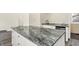 Kitchen island with granite countertop and white cabinets at 1175 Central Ave, Noblesville, IN 46060