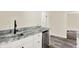Small kitchenette with granite countertop and stainless steel mini-fridge at 1175 Central Ave, Noblesville, IN 46060