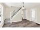 Living room with hardwood floors, staircase, and chandelier at 1175 Central Ave, Noblesville, IN 46060