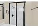 Clean shower with marble-style walls and black frame at 1175 Central Ave, Noblesville, IN 46060