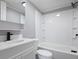 Clean bathroom with white vanity, tub, and shower at 12160 W Baker Hollow Rd, Columbus, IN 47201