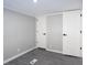 Empty bedroom with gray walls, wood-look floors, and double doors at 12160 W Baker Hollow Rd, Columbus, IN 47201
