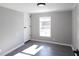 Bright bedroom with gray walls, wood-look floors, and a window at 12160 W Baker Hollow Rd, Columbus, IN 47201