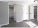 Bedroom with gray walls and access to the bathroom and other rooms at 12160 W Baker Hollow Rd, Columbus, IN 47201