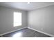 Simple bedroom with gray walls and wood-look floors at 12160 W Baker Hollow Rd, Columbus, IN 47201
