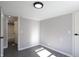 Spacious bedroom with gray walls, wood-look floors, and access to bathroom at 12160 W Baker Hollow Rd, Columbus, IN 47201