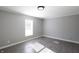 Simple bedroom with gray walls, wood-look floors, and a window at 12160 W Baker Hollow Rd, Columbus, IN 47201