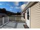 Grey deck with white railings overlooks a yard and trees at 12160 W Baker Hollow Rd, Columbus, IN 47201