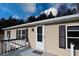 Tan mobile home with white door and black shutters at 12160 W Baker Hollow Rd, Columbus, IN 47201