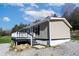 Home with a front deck, neutral siding and foundation blocks at 12160 W Baker Hollow Rd, Columbus, IN 47201