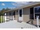 Inviting front porch showcasing a white door and neutral siding at 12160 W Baker Hollow Rd, Columbus, IN 47201