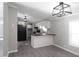 Modern kitchen featuring white cabinets, black appliances, and a breakfast bar at 12160 W Baker Hollow Rd, Columbus, IN 47201