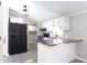 Modern kitchen with white cabinets, granite countertops and black appliances at 12160 W Baker Hollow Rd, Columbus, IN 47201