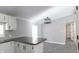 Modern kitchen with white cabinets, granite countertops and black appliances at 12160 W Baker Hollow Rd, Columbus, IN 47201