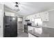 Modern kitchen with white cabinets, breakfast bar, and black appliances at 12160 W Baker Hollow Rd, Columbus, IN 47201