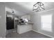 Modern kitchen with white cabinets, granite countertops, and black appliances at 12160 W Baker Hollow Rd, Columbus, IN 47201