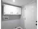 Laundry room with white cabinets and gray walls at 12160 W Baker Hollow Rd, Columbus, IN 47201