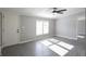 Spacious living room featuring gray walls, wood-look floors, and a ceiling fan at 12160 W Baker Hollow Rd, Columbus, IN 47201