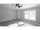 Living room with gray walls, wood-look floors, and a ceiling fan at 12160 W Baker Hollow Rd, Columbus, IN 47201