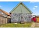 Rear view of house showing peeling paint and yard at 14 N Tacoma Ave, Indianapolis, IN 46201