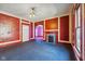 Living room with red walls, blue carpet, and fireplace at 14 N Tacoma Ave, Indianapolis, IN 46201