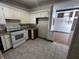 Galley kitchen with white cabinets and vinyl flooring at 1623 Sherwood Dr, Anderson, IN 46012