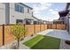 Private backyard with modern fence, artificial turf area, rock garden, and blooming tree at 1674 Solebar Way, Westfield, IN 46074