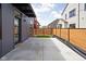Modern backyard with wood fence, concrete patio, and small grass area, offering a blend of privacy and low-maintenance design at 1674 Solebar Way, Westfield, IN 46074