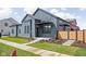 Modern home boasts sleek lines, a covered entryway, fresh landscaping, and a well-maintained lawn at 1674 Solebar Way, Westfield, IN 46074