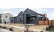 Modern two-story home featuring a stylish gray exterior, complemented by sleek black window frames and a minimalist landscape at 1674 Solebar Way, Westfield, IN 46074