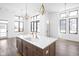 Open concept kitchen with island, stainless steel appliances, hardwood floors, and a view of the living space at 1674 Solebar Way, Westfield, IN 46074