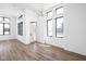 Bright, modern living room with hardwood floors, tall ceilings, large windows, and contemporary lighting fixtures at 1674 Solebar Way, Westfield, IN 46074