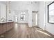 Bright open-concept living space with hardwood floors, modern light fixtures, and abundant natural light from large windows at 1674 Solebar Way, Westfield, IN 46074
