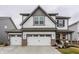 Charming two-story home with white siding, stone accents, and an attached two-car garage at 17227 Barnes St, Westfield, IN 46074