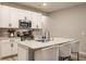 Bright kitchen featuring white cabinets, granite countertops, stainless steel appliances, and a functional island with barstool seating at 17227 Barnes St, Westfield, IN 46074