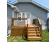 Exterior shot showcasing a wooden deck with black railings and steps leading to the yard at 18 S Franklin St, Greenfield, IN 46140