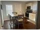 Eat-in kitchen featuring stainless steel appliances, white cabinetry, and hardwood flooring at 18 S Franklin St, Greenfield, IN 46140
